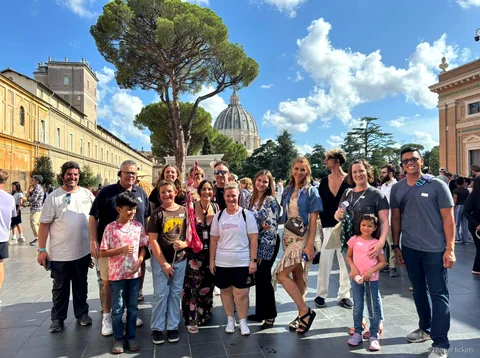 Guide pointing out frescoes on the Vatican Museums and Sistine Chapel tour
