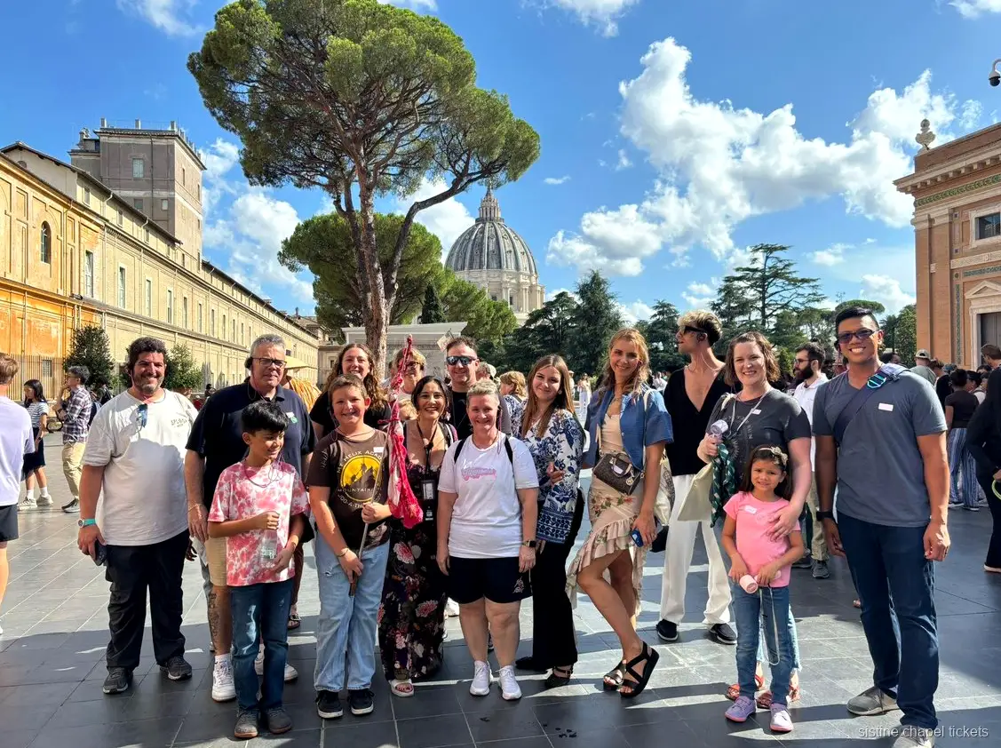 Guide pointing out frescoes on the Vatican Museums and Sistine Chapel tour